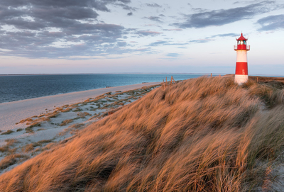 Landscape with sand dunes and a lighthouse